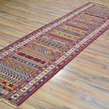 Load image into Gallery viewer, Colorful patterned rug on a wooden floor