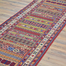 Load image into Gallery viewer, Colorful patterned rug on a wooden floor