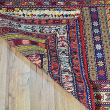 Load image into Gallery viewer, Colorful patterned rug on a wooden floor