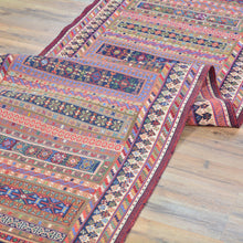 Load image into Gallery viewer, Colorful patterned rug on a wooden floor