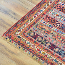 Load image into Gallery viewer, Decorative rug with intricate patterns on a wooden floor