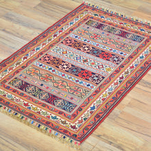 Load image into Gallery viewer, Colorful patterned rug on a wooden floor