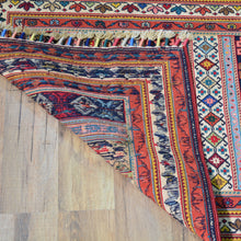 Load image into Gallery viewer, Colorful patterned rug on a wooden floor