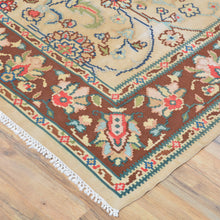 Load image into Gallery viewer, Top view of Bulgarian kilim area rug 6x9, ivory ground with brown and green tribal motifs