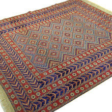 Load image into Gallery viewer, Detail of Soumak weave texture showing red and blue geometric tribal design, 100% wool